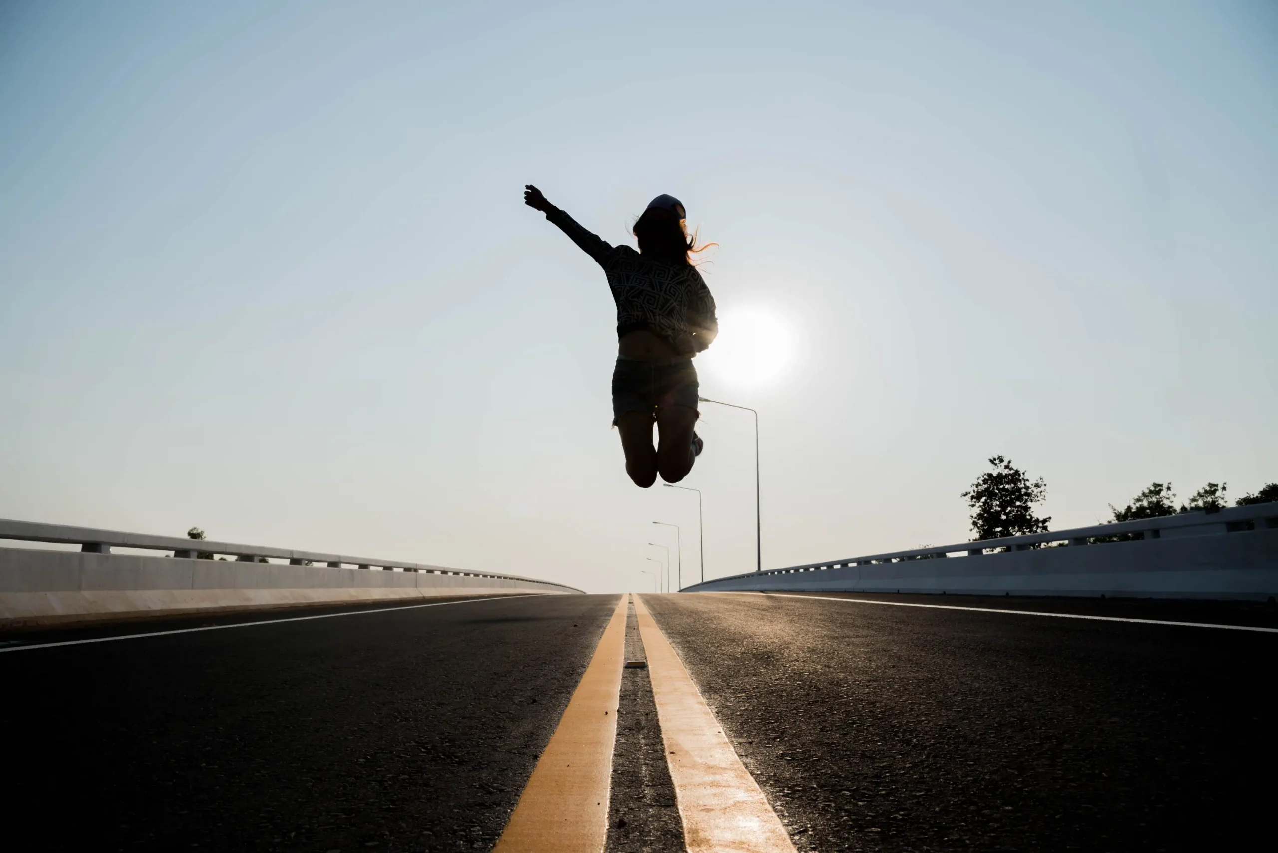 silhouette woman jumping road scaled