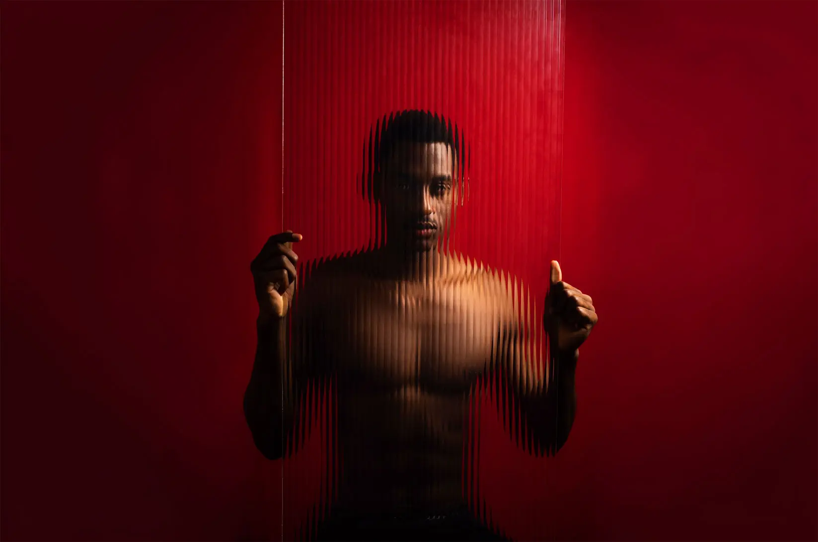 Man behind striped translucent screen