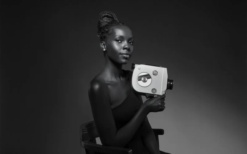 Woman holding vintage film camera.