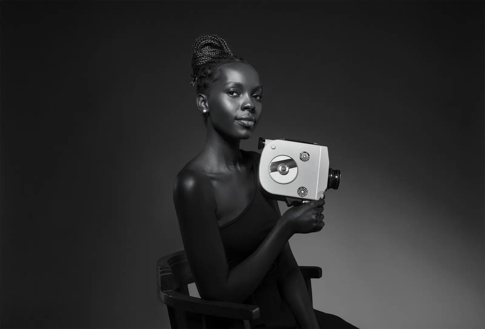 Woman holding vintage film camera.